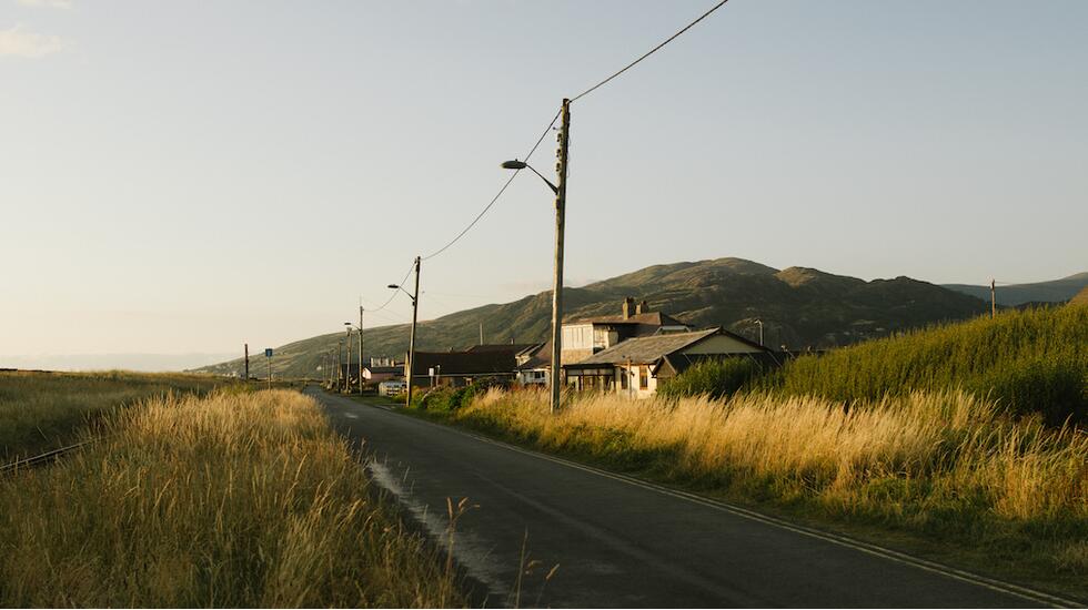 A white house along a road in Wales