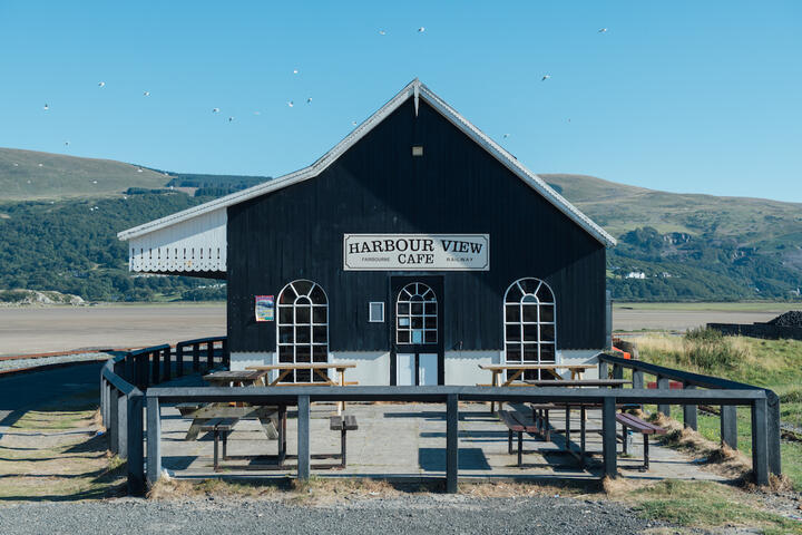 A black hut, The Harbour Cafe, on the shore