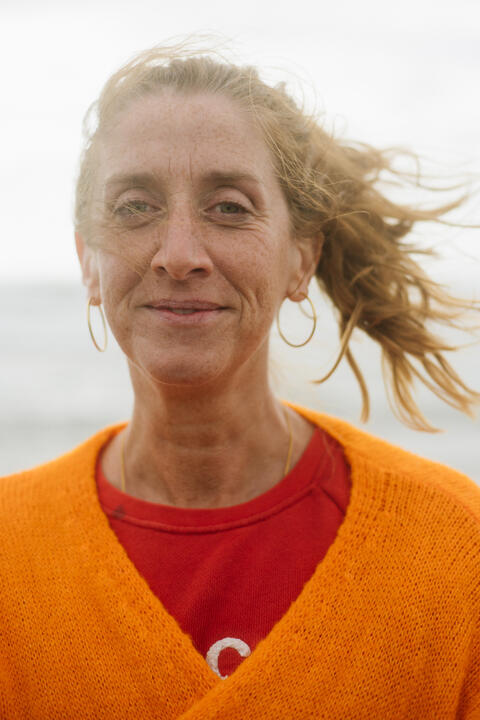 A resident of Fairbourne looks directly at the camera, wearing an orange jumper