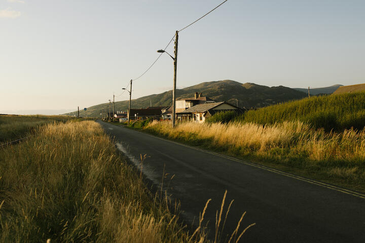 Houses sat along a single track lane beneath low mountains