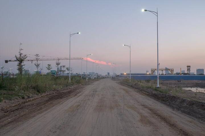 Streetlights give a glimpse of what will soon be a road leading to the center of the capital.