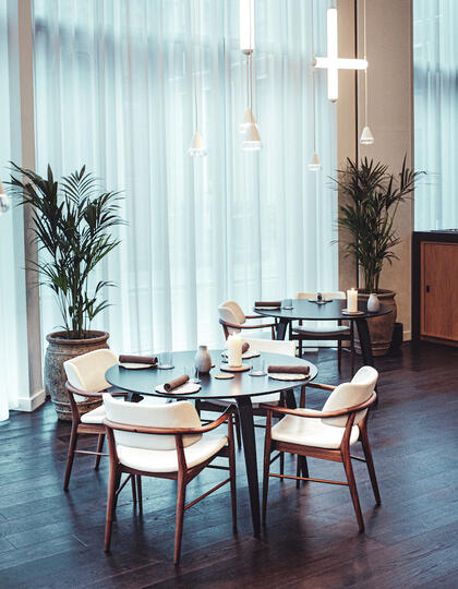 A round dining table in an airy dining room