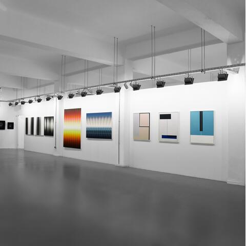 Art hung in a white gallery space