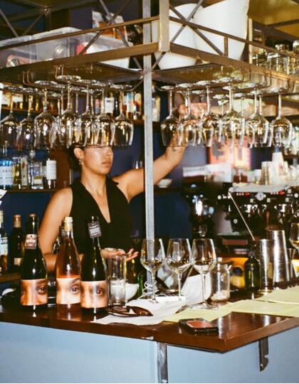 A woman behind a bar