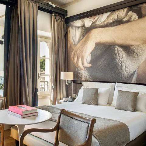 A bedroom suite at Villa Agrippina Gran Meliá, a boutique hotel in Rome